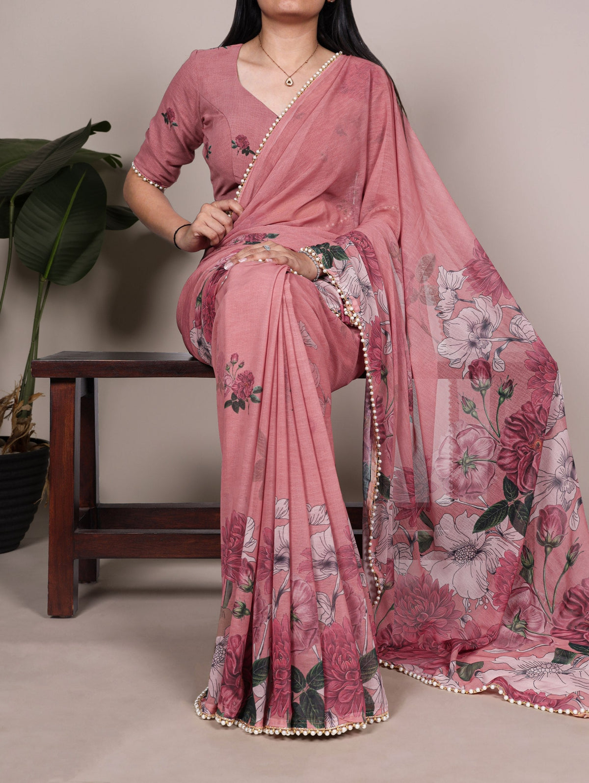 Peach floral saree illustrating clean saree fall and pico finishing at the hem