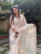 Load image into Gallery viewer, Elegant Off-White Pure Linen Digital Printed Saree with Striped Design and Unique Black Motif Pallu – Comes with Blouse Piece and Tassels LINEN