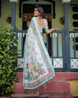 Load image into Gallery viewer, Ivory Pure Cotton Linen Saree with Elephant Motif and Floral Pattern, Green and Pink Borders, and Tassels on Edges. LINEN