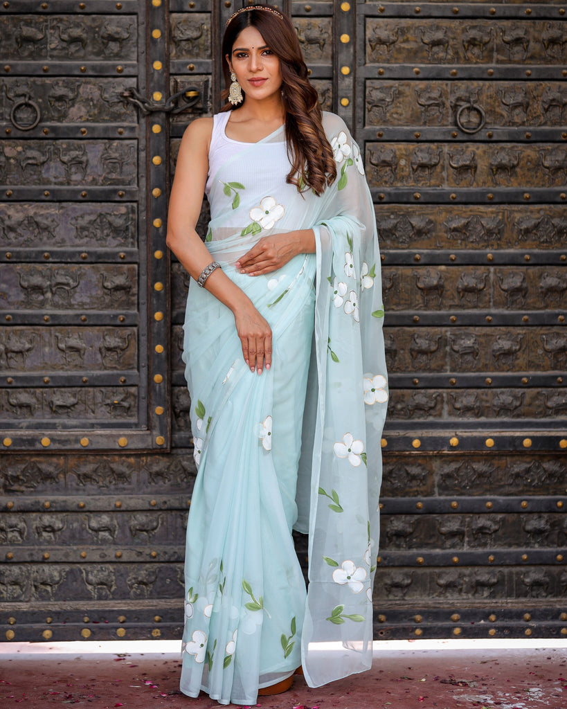 Pastel Blue Georgette Saree with Hand-Painted White Floral Motifs & Green Leaves – Attached Blouse – 5.5 Meters FANCY SAREES