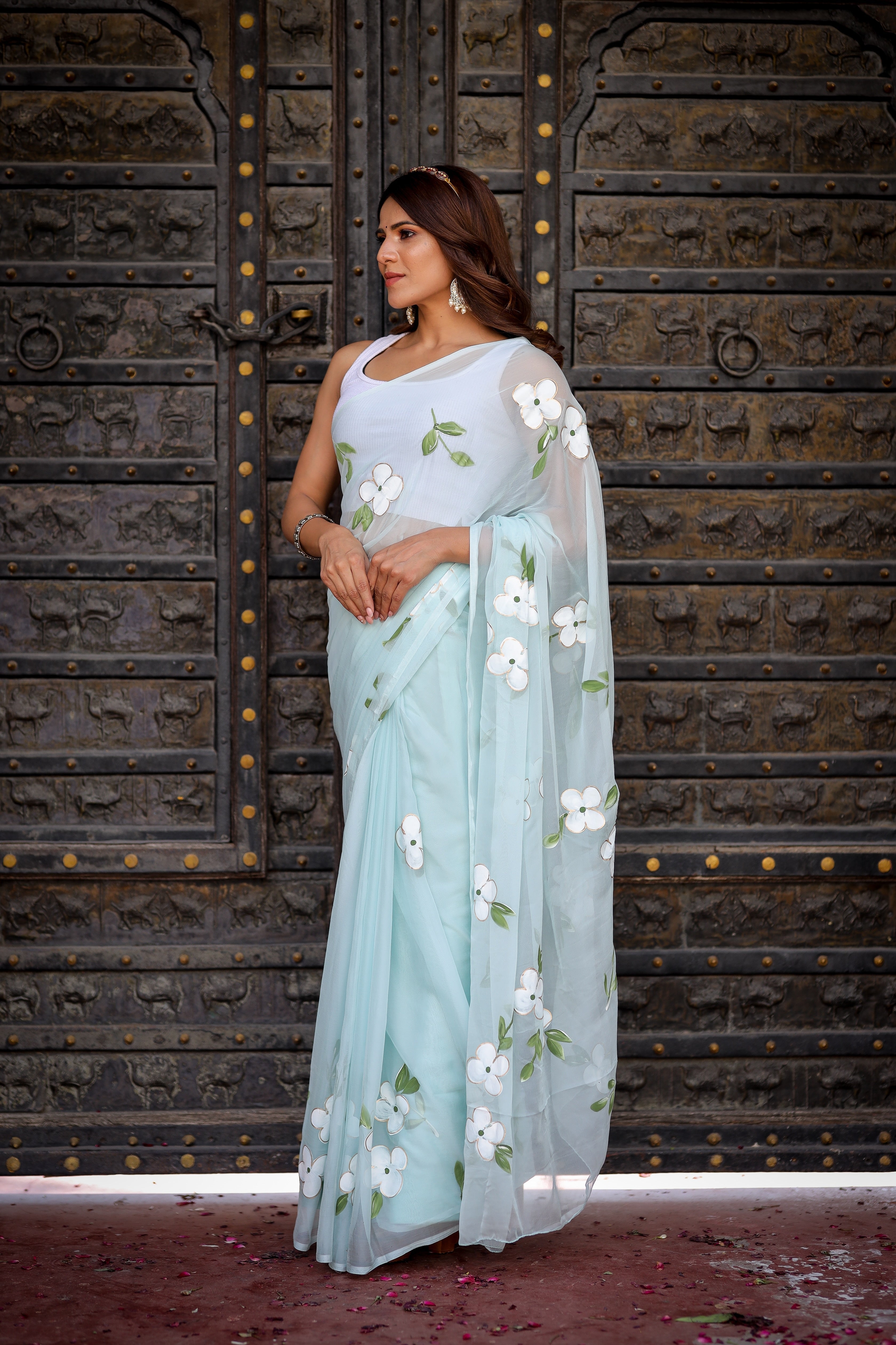 Pastel Blue Georgette Saree with Hand-Painted White Floral Motifs & Green Leaves – Attached Blouse – 5.5 Meters FANCY SAREES