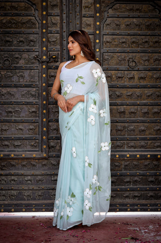 Pastel Blue Georgette Saree with Hand-Painted White Floral Motifs & Green Leaves – Attached Blouse – 5.5 Meters FANCY SAREES