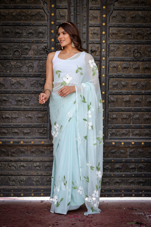 Pastel Blue Georgette Saree with Hand-Painted White Floral Motifs & Green Leaves – Attached Blouse – 5.5 Meters FANCY SAREES
