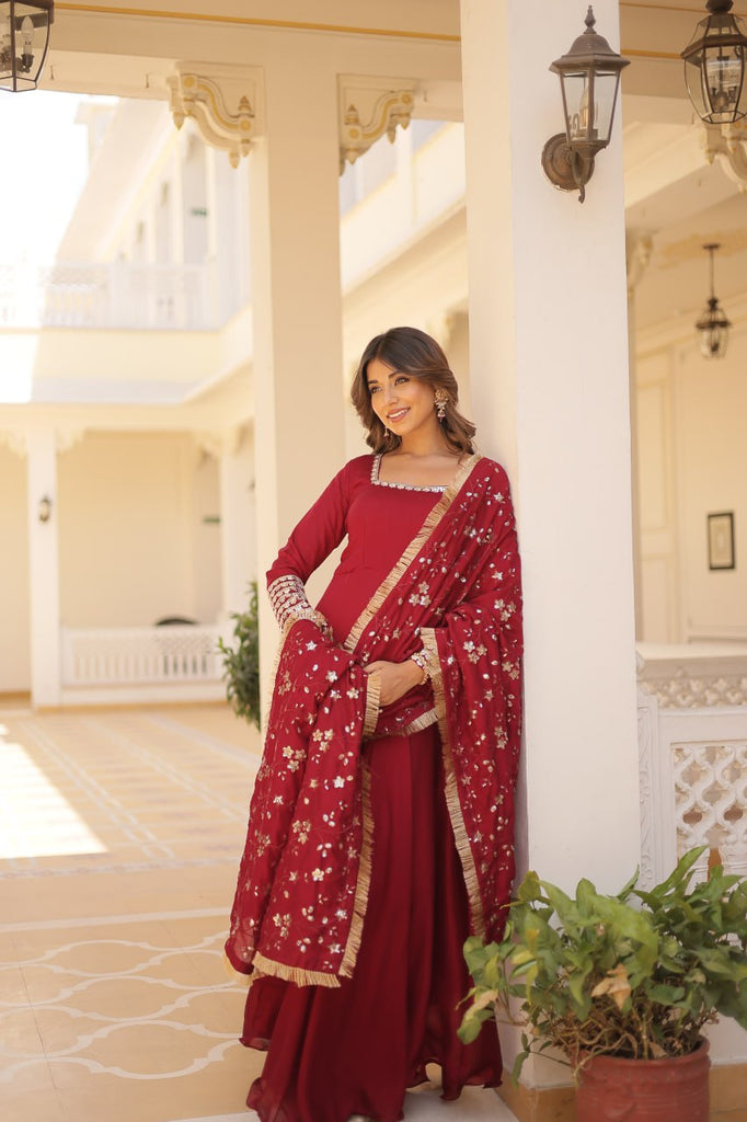 Embrace timeless elegance with our meticulously crafted Vichitra silk Maroon gown and dupatta set. ClothsVilla