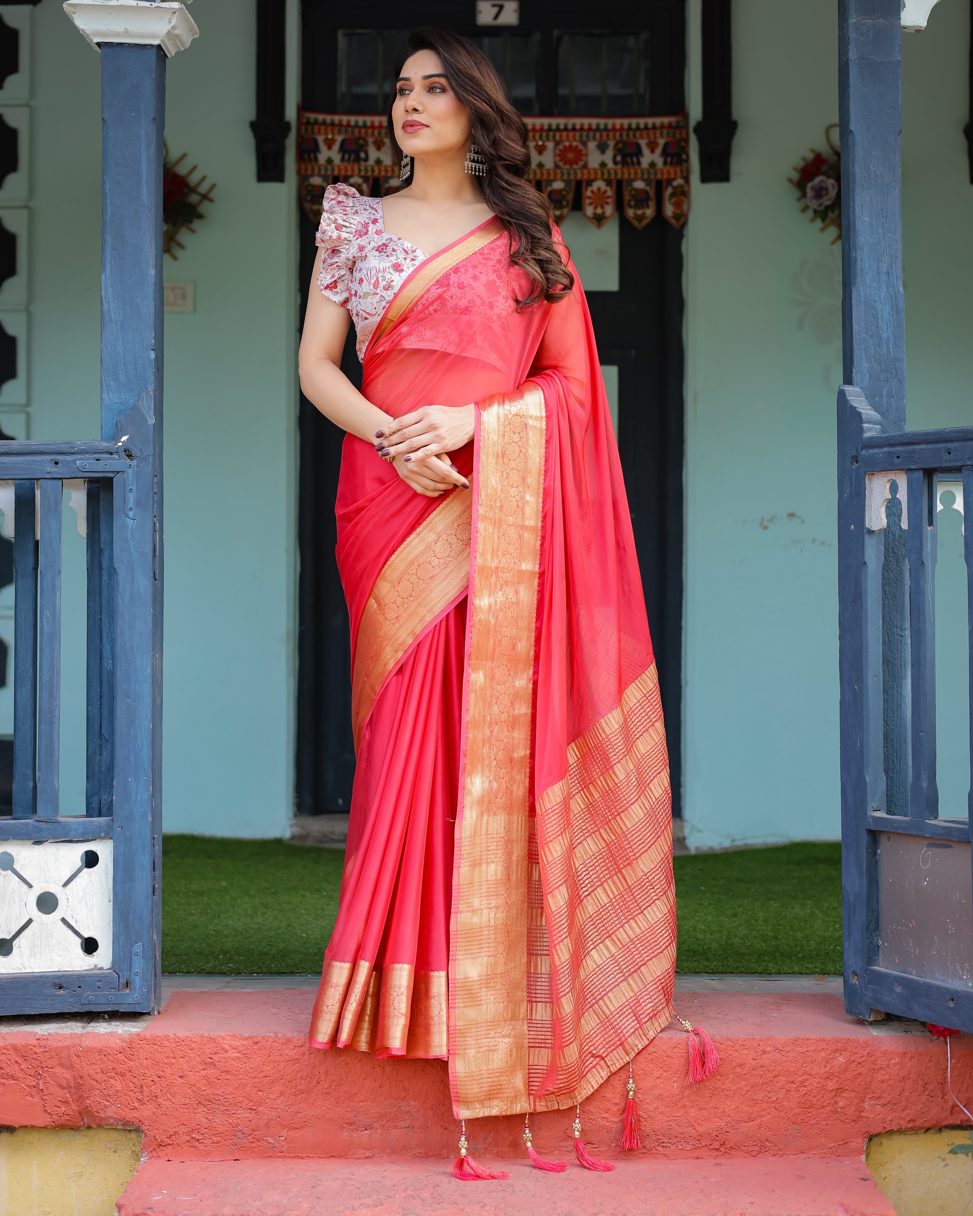 Vibrant Coral Pink Plain Chiffon Saree with Gold Zari Border, Floral Ruffled Blouse & Tassel Detailing CHIFFON Main image