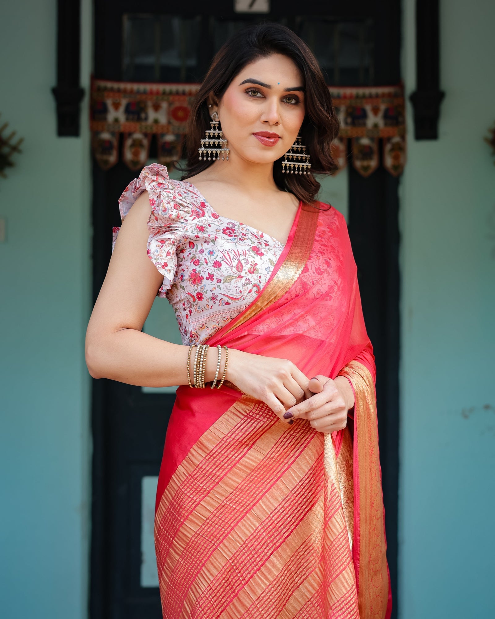 Vibrant Coral Pink Plain Chiffon Saree with Gold Zari Border, Floral Ruffled Blouse & Tassel Detailing CHIFFON