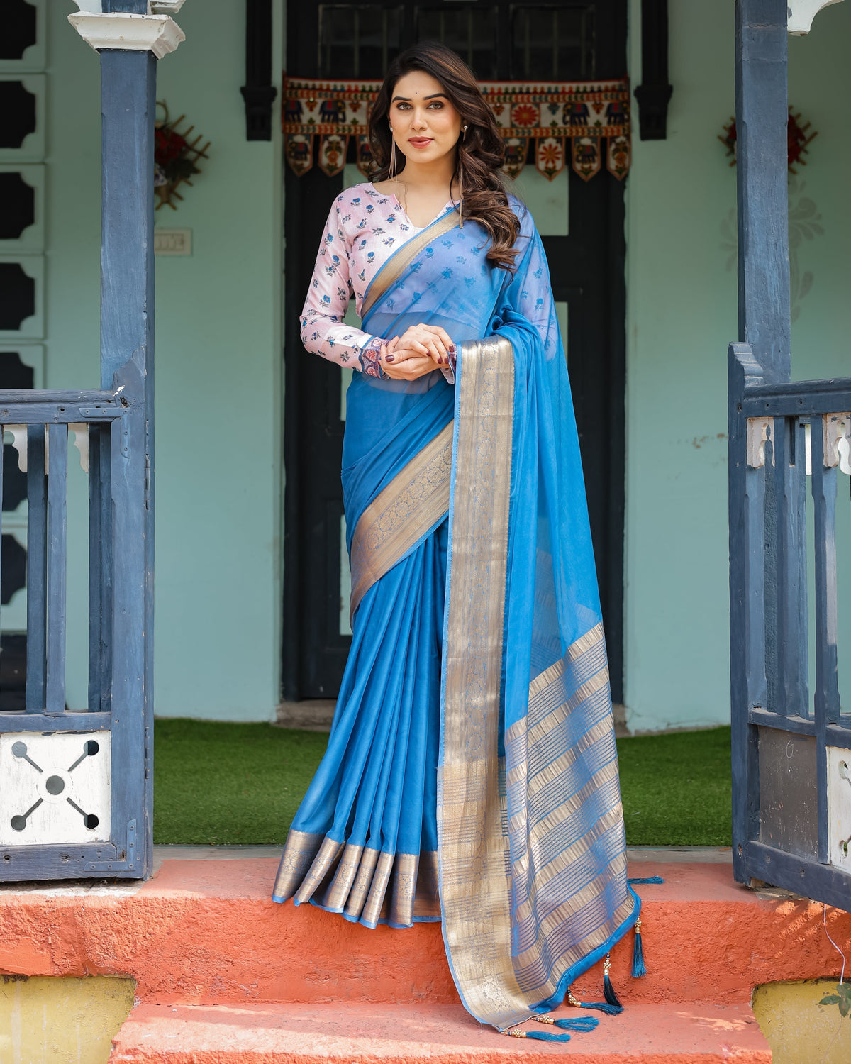 Vibrant Sky Blue Plain Chiffon Saree with Gold Zari Border, Floral Printed Blouse & Tassel Accents CHIFFON Main image