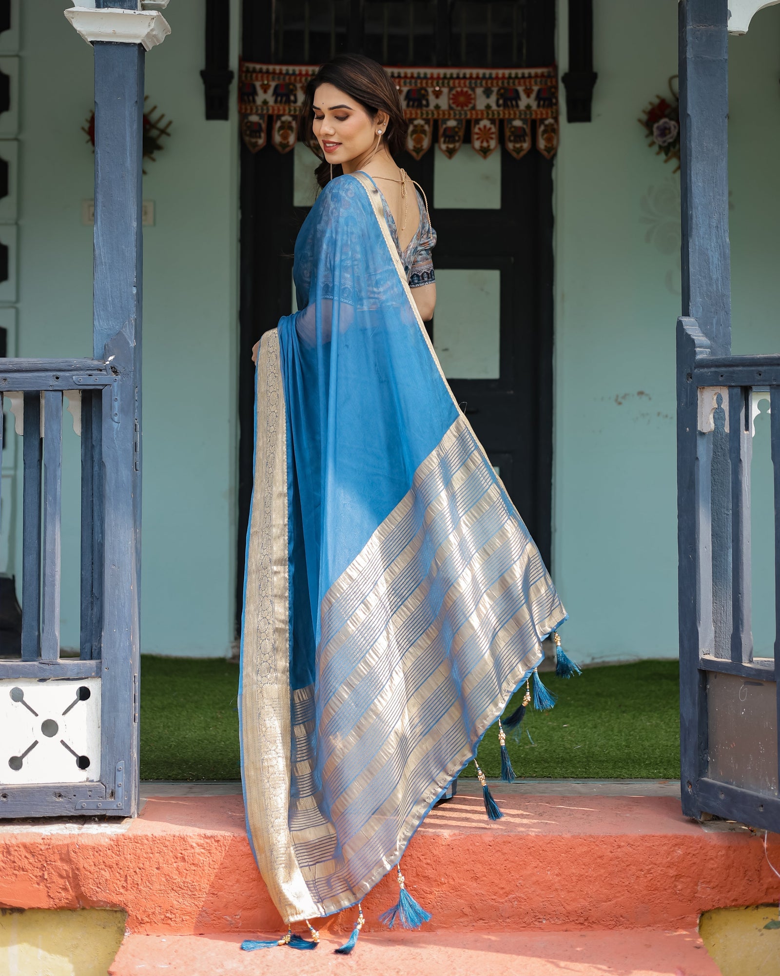 Vibrant Peacock Blue Plain Chiffon Saree with Gold Zari Border, Floral Printed Blouse & Tassel Accents CHIFFON