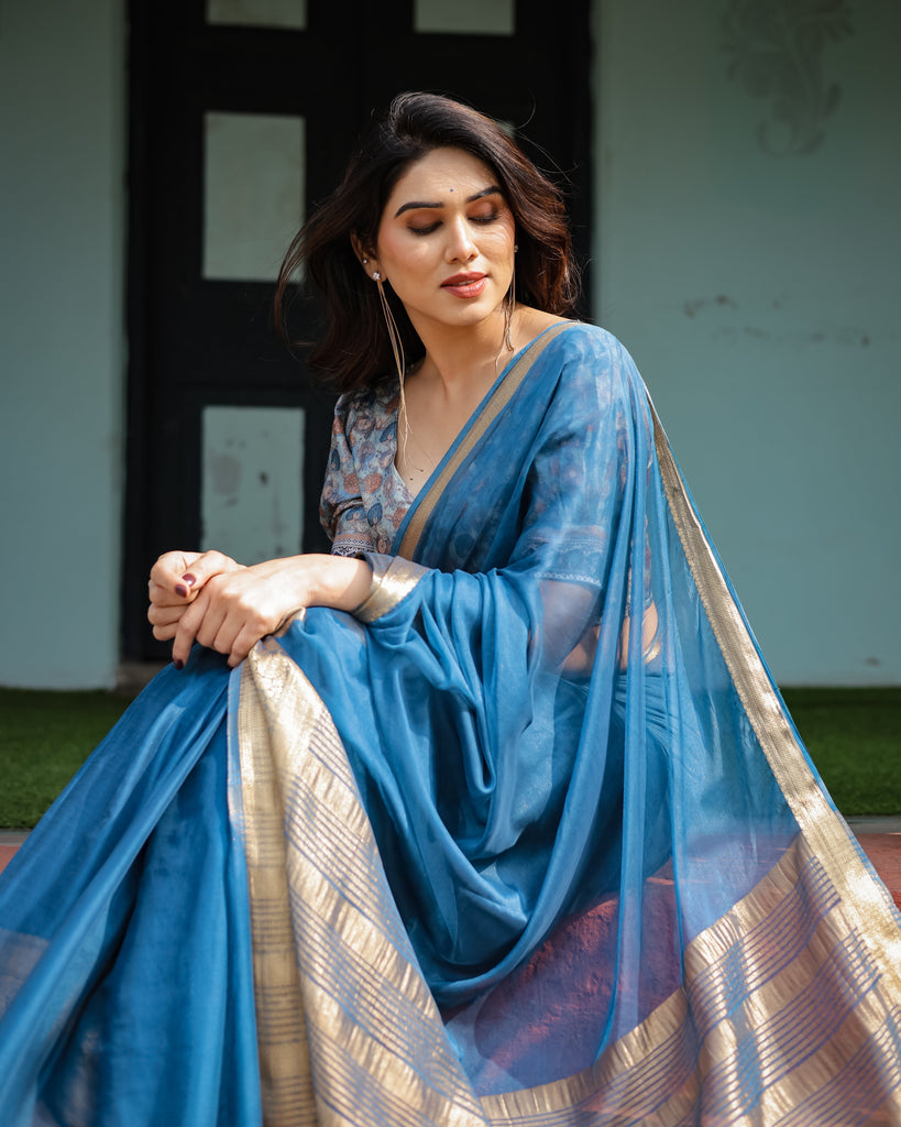 Vibrant Peacock Blue Plain Chiffon Saree with Gold Zari Border, Floral Printed Blouse & Tassel Accents CHIFFON