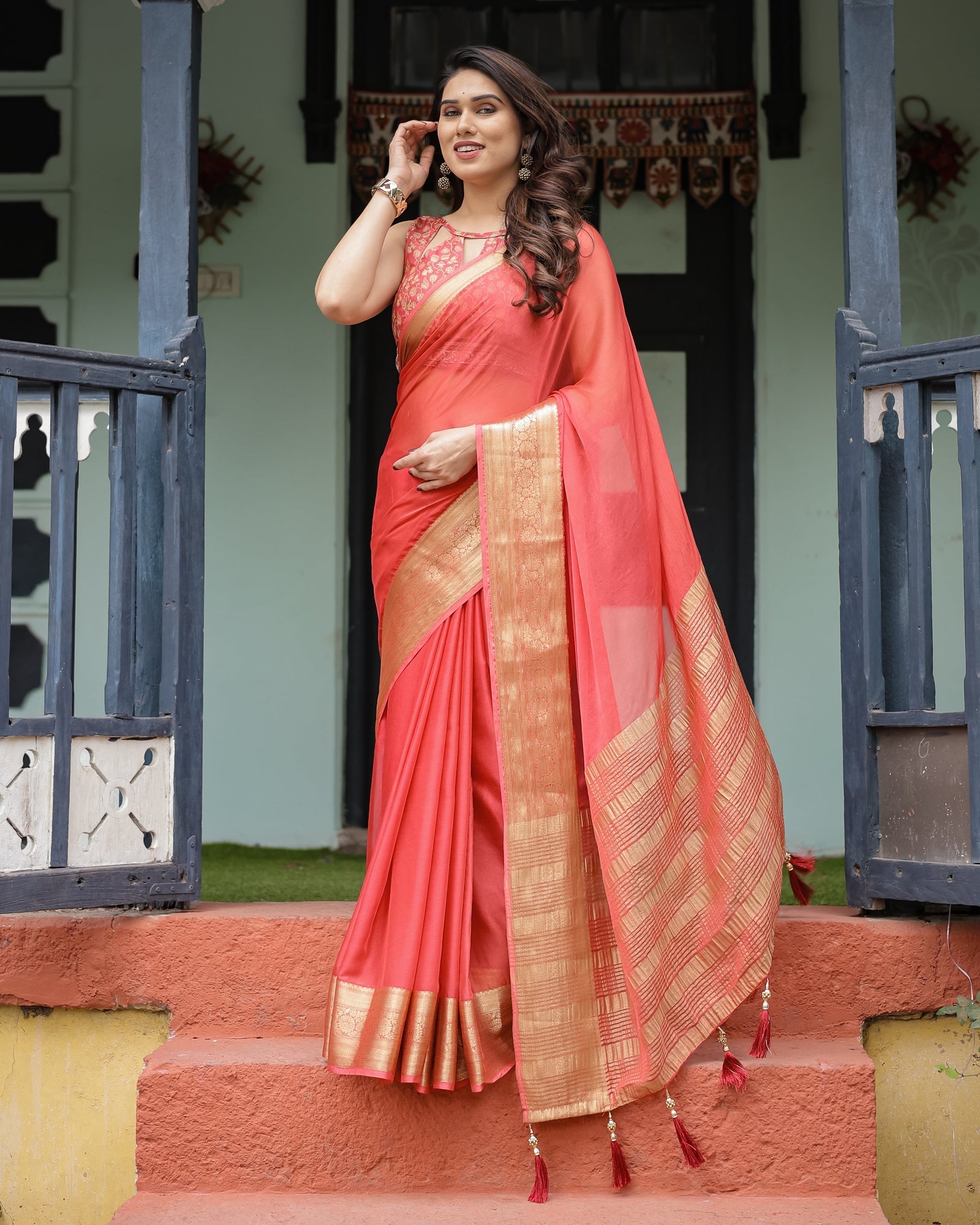 Graceful Coral Pink Plain Chiffon Saree with Gold Zari Border, Floral Embroidered Blouse & Tassel Detailing CHIFFON