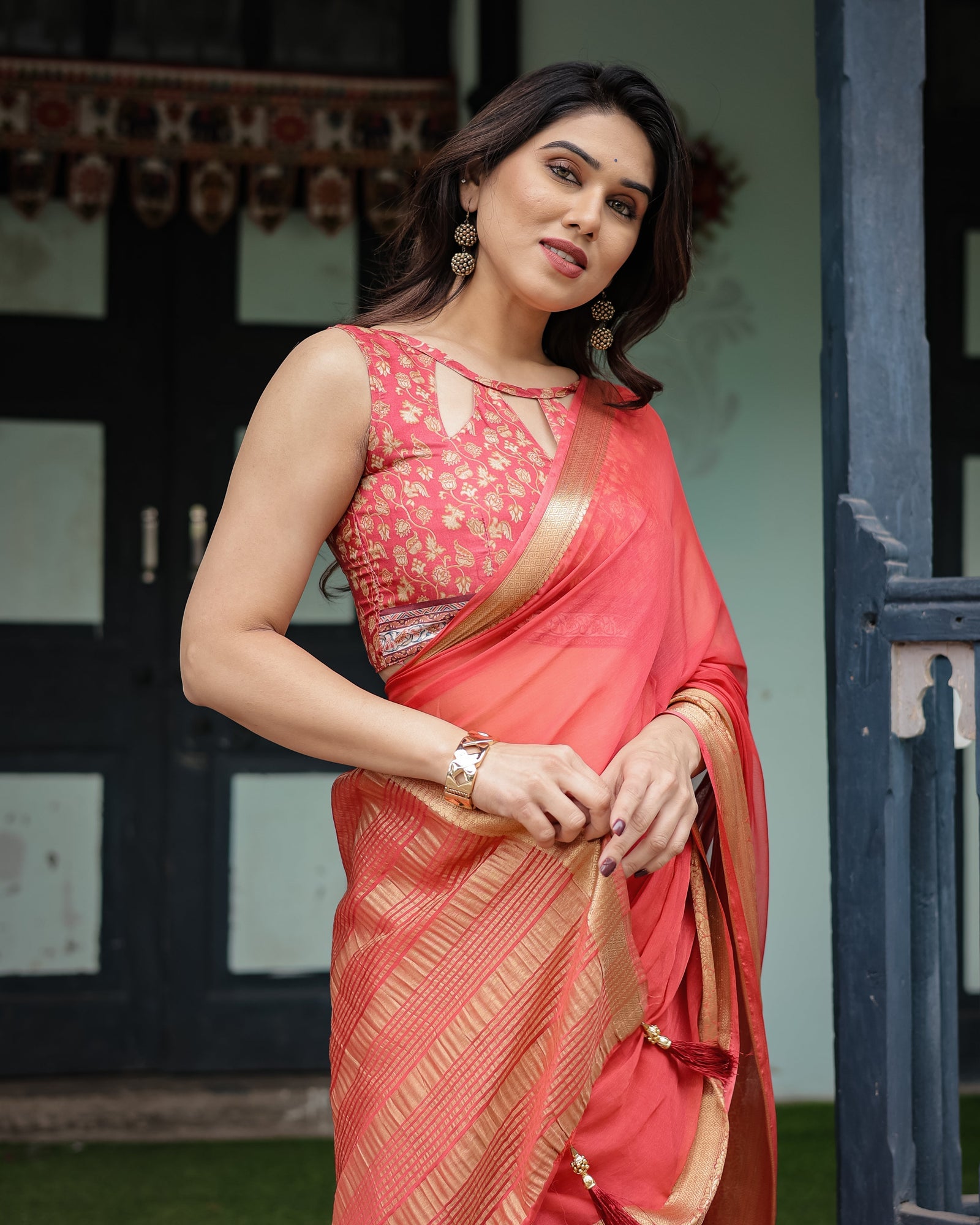 Graceful Coral Pink Plain Chiffon Saree with Gold Zari Border, Floral Embroidered Blouse & Tassel Detailing CHIFFON