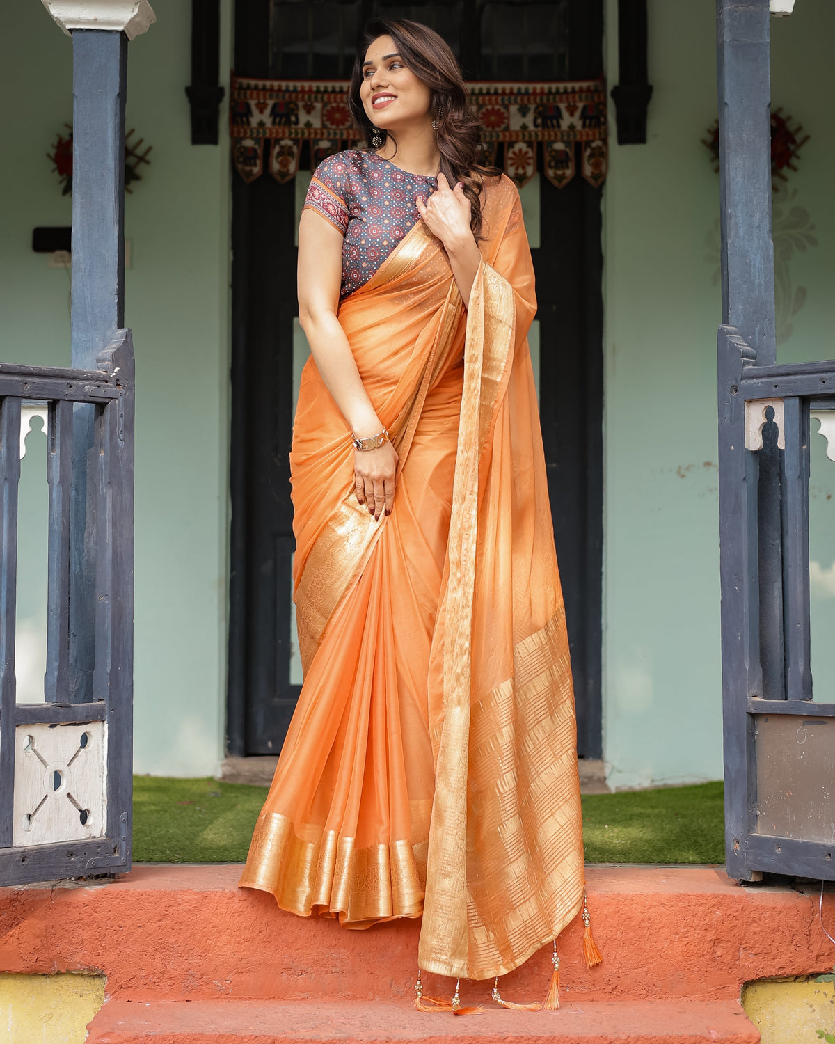 Elegant Tangerine Orange Plain Chiffon Saree with Gold Zari Border, Geometric Printed Blouse & Tassel Detailing CHIFFON Main image