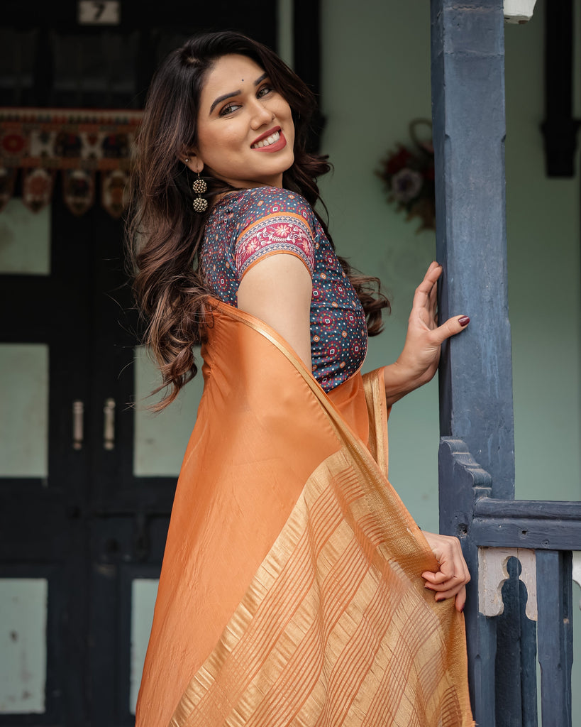 Elegant Tangerine Orange Plain Chiffon Saree with Gold Zari Border, Geometric Printed Blouse & Tassel Detailing CHIFFON