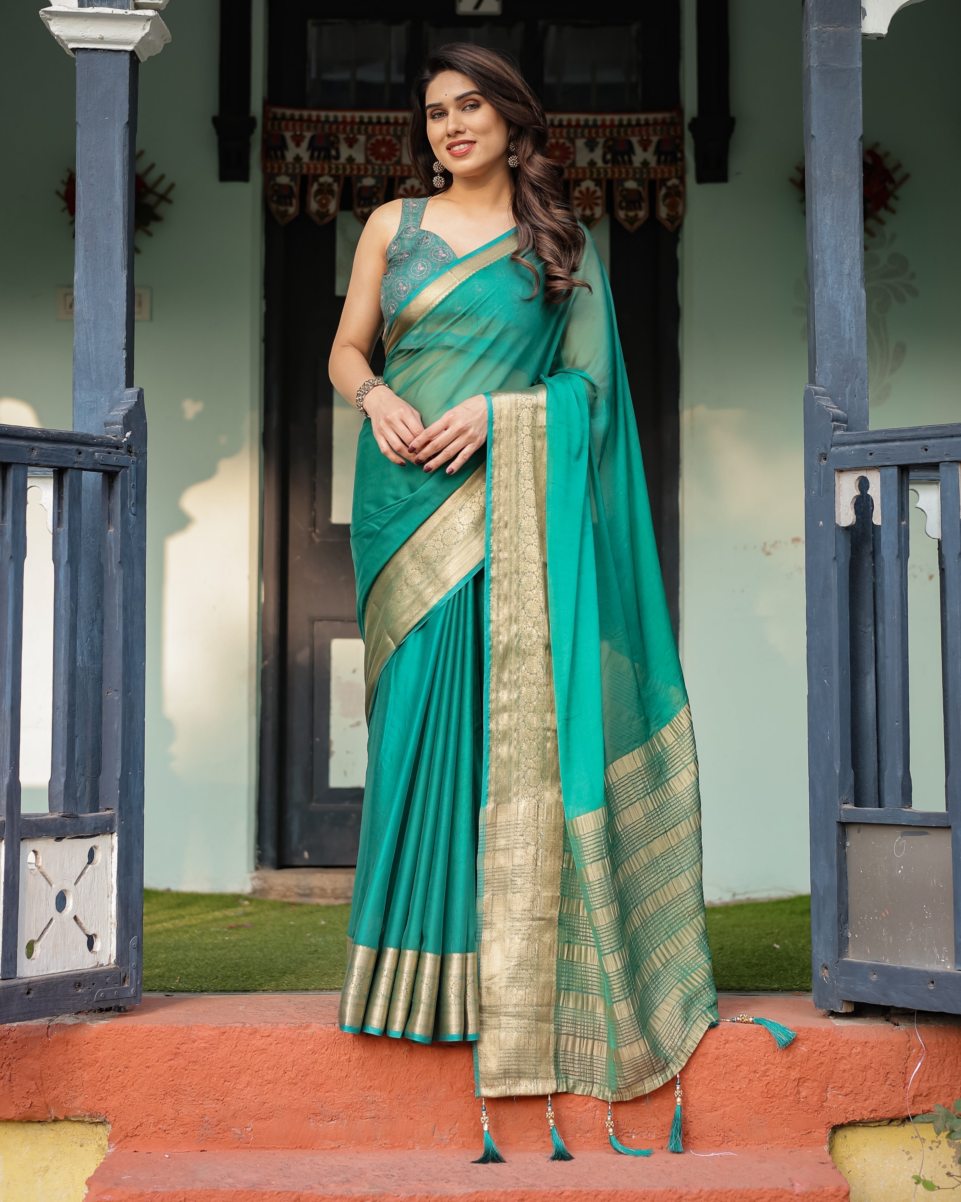 Elegant Sea Green Plain Chiffon Saree with Gold Zari Border, Paisley Printed Blouse & Tassel Detailing CHIFFON Main image