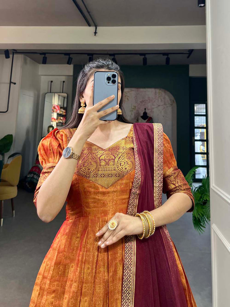 Regal Orange Zari Woven Kanjivaram Gown with Net Dupatta ClothsVilla