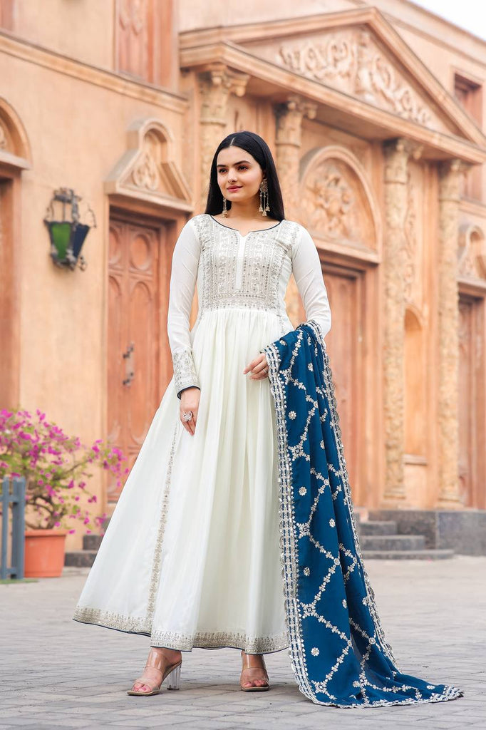 white anarkali designer dress Designer White Anarkali Dress , Step into elegance with this white Anarkali suit crafted in soft faux georgette fabric, adorned with delicate multi-thread embroidery work on the sleeves and border.