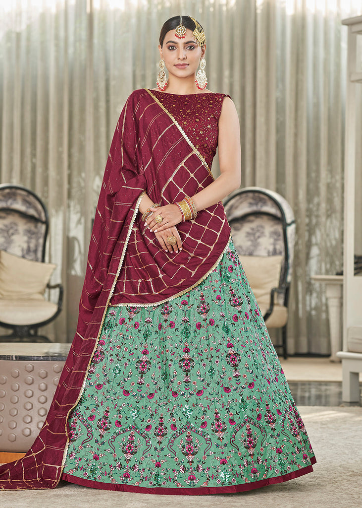 Bridal lehenga paired with green color heavily embellished choli comes with  one maroon velvet embroidered shaw dupatta and net green dupatta with  embroidery. |lovelyweddingmall.com|