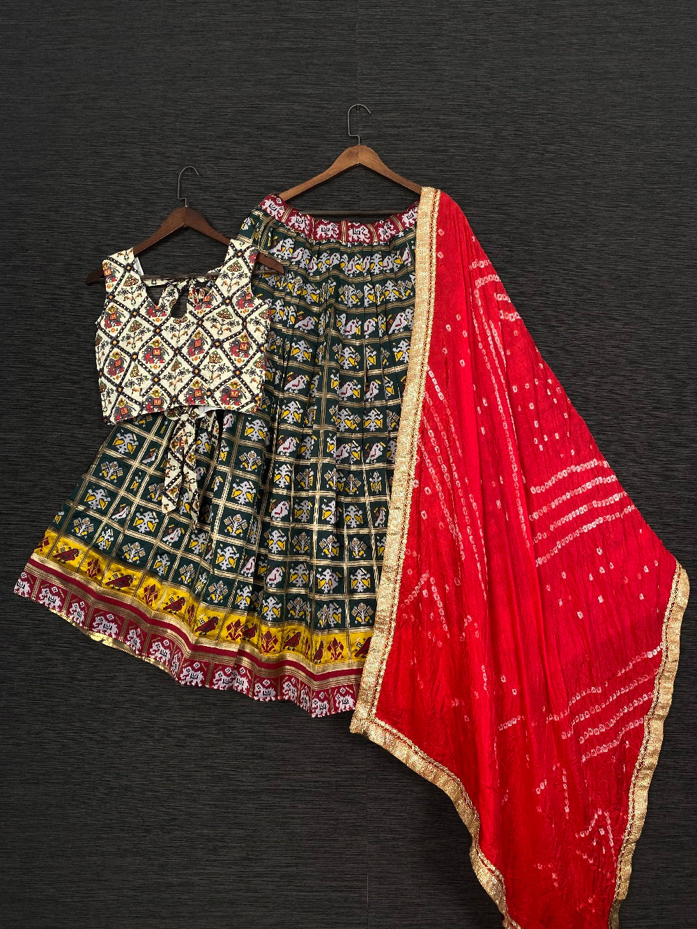 Green Color Jacquard Patola Chaniya Choli With Red Bandhej Silk Dupatta Clothsvilla Main image
