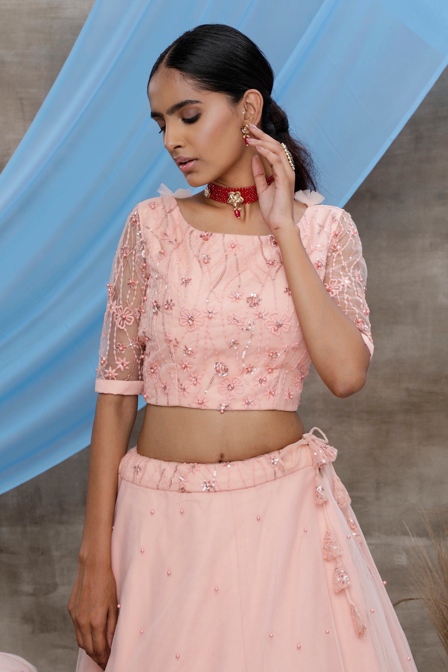 Peach Thread And Sequence Embroidered With All Over Pearl Rivet Stud Pasting Net Semi Stitched Bridal Lehenga ClothsVilla